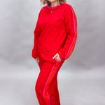 FATE red crewneck top and wide-leg pants set with pink stripes; angled model view.