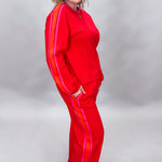 FATE red crewneck top and wide-leg pants set with pink stripes; angled model view.