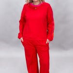 FATE red crewneck top and wide-leg pants set with pink stripes; front model view.