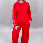 FATE red crewneck top and wide-leg pants set with pink stripes; front model view.