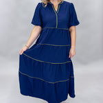 Mary Square navy tiered dress with contrast piping and short puffed sleeves; front model view.