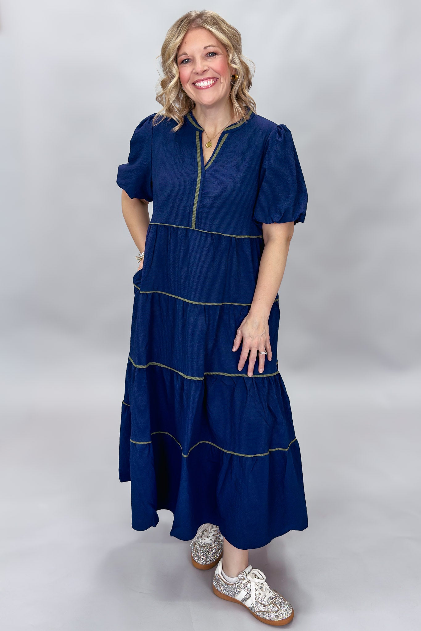 Mary Square navy tiered dress with contrast piping and short puffed sleeves; front model view.