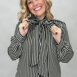 FATE black and cream striped tie-neck blouse with gathered cuffs; front model view.