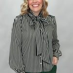 FATE black and cream striped tie-neck blouse with gathered cuffs; front model view.