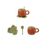 Creative Co-Op orange pumpkin mug with green leaf saucer and spoon; assembled and separate views of the three-piece set